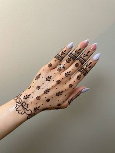 a woman's hand with hendix on it and flowers painted on the palm