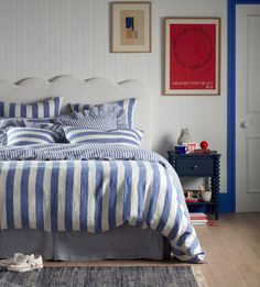 a blue and white striped bed in a bedroom