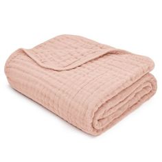 a pink blanket is folded on top of a white background