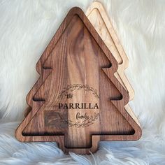 three wooden cutting boards sitting on top of a white furnishing area with the words parrilla engraved on them