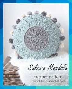 a crocheted pillow with pom - poms on it and the words, sa