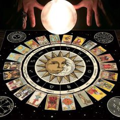 the sun and moon tarot board is shown in front of someone's hands