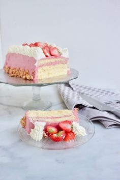 two slices of cake with strawberries on the top and one slice missing from it