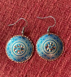 These traditional handmade earrings are made with a type of handiwork that dates back to the 17th Century in the Ottoman Empire. The gorgeous craftsmanship is rare and only 8 people are capable of this kind of handiwork today. Because of this, the craft of etching in copper is estimated to last for only another 10-15 years.  These are classic and timeless designs. The hooks of the earrings are Stainless Steel, and the jewellery itself is 100% Copper, which make them so lightweight. The backs are coated with Silver Nitrate, and both sides are polished with a high quality varnish so these pieces will not tarnish or discolour, are hypo-allergenic, and will hopefully get you compliments for time to come! Artisan Copper Beaded Earrings As Gift, Artisan Copper Beaded Earrings For Gift, Traditional Multicolor Brass Earrings, Traditional Etched Silver Earrings, Traditional Silver Etched Earrings, Multicolor Round Copper Jewelry, Vintage Hand Painted Jewelry For Festival, Traditional Adjustable Medallion Jewelry, Handmade Blue Beaded Metal Earrings