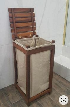 a wooden chair sitting on top of a hard wood floor next to a white wall