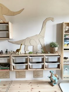 a toy dinosaur is sitting on the shelf