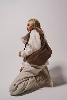 Sling style faux sherpa fabrication adjustable sherpa-padded shoulder strap mini strap pocket hidden side zipper pocket zipper closure Pink Sherpa Bag, Sweat Sherpa, Fabric Sherpa, Boho Tote Bag, Free People Bags, Tote Outfit, Boho Tote, Brown Crossbody Bag, Sweatsuit Set