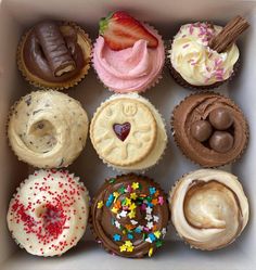 a box filled with lots of different types of cupcakes