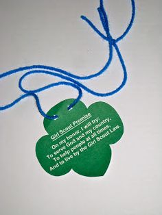 a four leaf clover shaped tag with a blue string attached to it that says, good luck and happiness