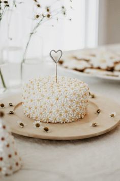 a heart shaped cake sitting on top of a wooden plate