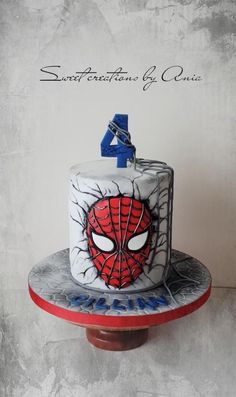 a spiderman birthday cake with the number four on it