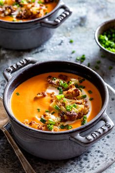 two bowls filled with soup on top of a table