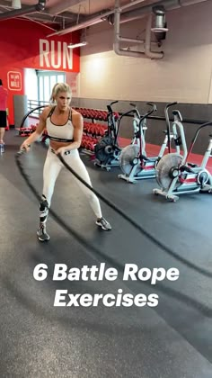 a woman is doing exercises in the gym while holding a rope and wearing roller blades