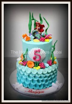 the little mermaid birthday cake is decorated with fondant and seaweed, shells, and seashells