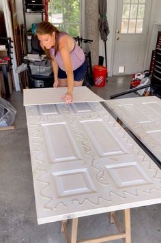 a woman working on an unfinished piece of furniture