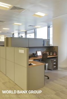 an office cubicle with desks and chairs