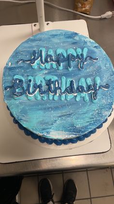 a birthday cake with blue frosting that says happy birthday