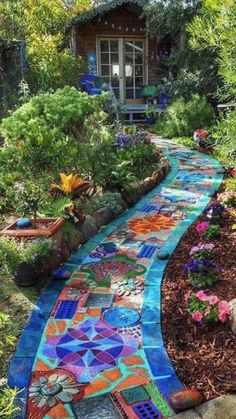 a garden path made out of colorful tiles