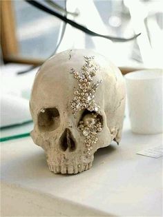 a white skull sitting on top of a table