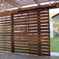 a wooden fence with lights hanging from it