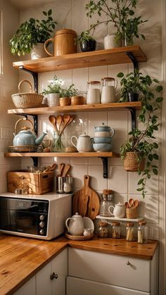 a kitchen filled with lots of pots and pans on top of wooden shelves next to a microwave oven