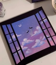 an image of a window with birds flying in the sky and clouds painted on it