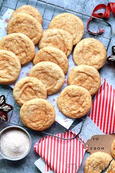 several cookies are on a cooling rack with red and white napkins next to them