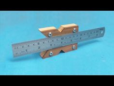 a wooden ruler sitting on top of a blue surface