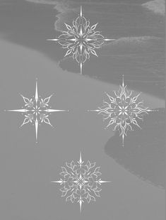 four snowflakes floating on top of a body of water next to the ocean