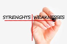 a hand writing the word strength and weakness on a whiteboard with red marker