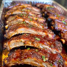 ribs covered in bbq sauce and garnished with parsley sprinkled on top