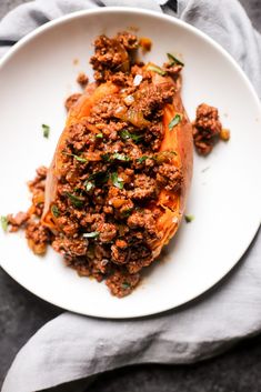 a white plate topped with meat covered in sauce