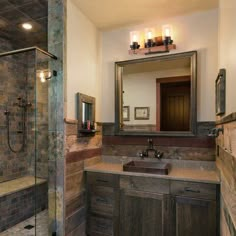 a bathroom with a walk in shower next to a sink and a mirror on the wall