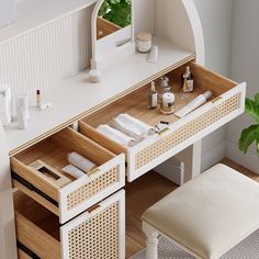 a white vanity table with drawers and stools