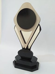 a black and white trophy with a wooden base