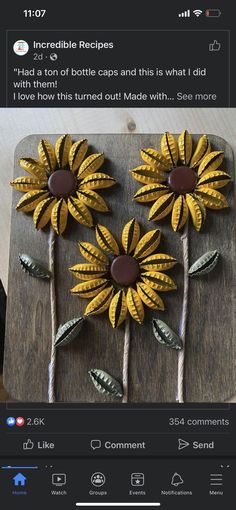 two yellow sunflowers are on a wooden board with rope and brown dots in the middle