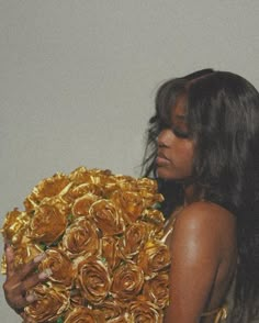 a woman holding a large bouquet of flowers