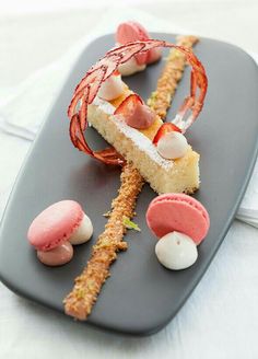 there is a dessert on the plate with fruit and cream toppings, including strawberries