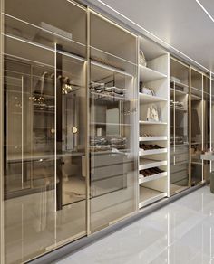 an empty walk - in closet with glass doors and shelves