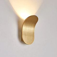 a light that is on the wall next to a white wall with an object in it