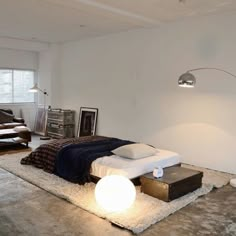 a bed sitting on top of a white rug in a bedroom next to a window