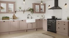 a kitchen with pink cabinets and white walls