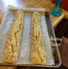 two long bread sticks sitting on top of a pan