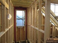 the inside of a house being built with wooden walls and beams in place for insulation