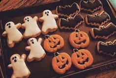 decorated cookies in the shape of ghost and pumpkins