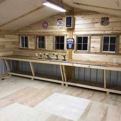 the inside of a wooden building with several windows