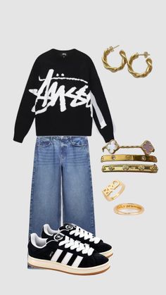 a black sweater, jeans and sneakers with gold accessories