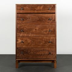 the chest of drawers is made out of wood and has five drawers on each side