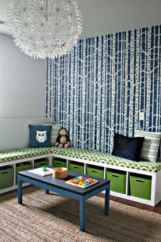 a child's playroom with blue and white wallpaper, green storage bins, and a bench