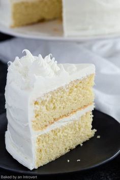 a slice of white cake on a black plate